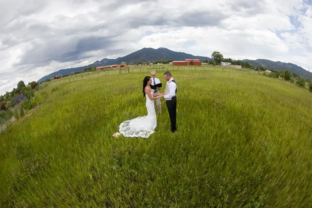 An aerial view of a couple getting married in the meadow at SpiriTaos
