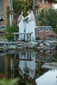 Bridal photo in front of the reflecting pond at SpiriTaos Gardens