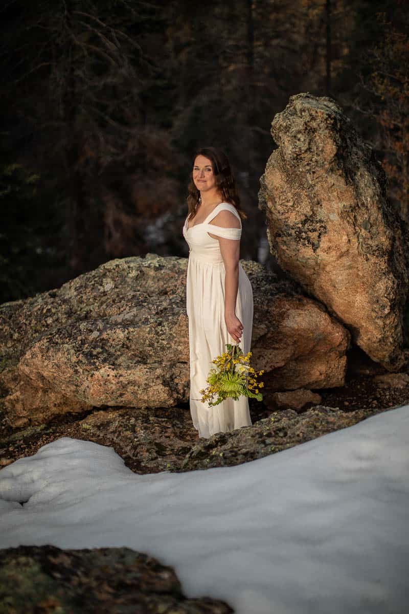 The lovely bride poses for her portrait. There's a bit of snow on the ground at this altitude!