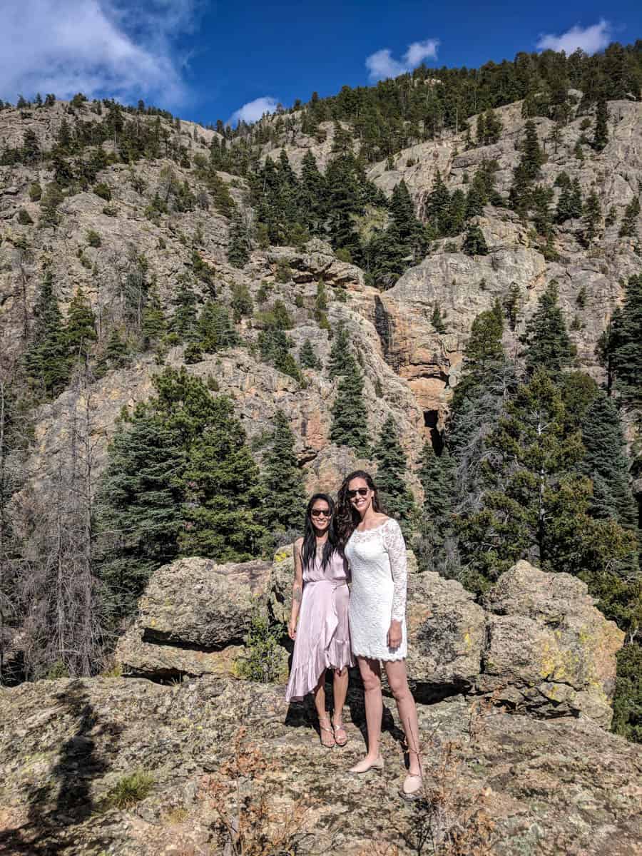 Newlywed brides pose for a photo in the Taos mountains.