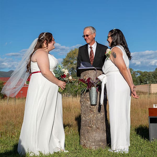 Officiant Dan Jones performs a wedding for two brides