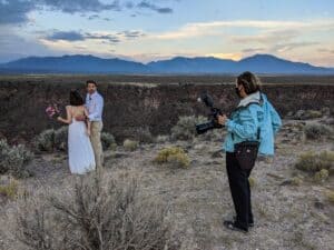 Photographer discussing wedding photos with couple