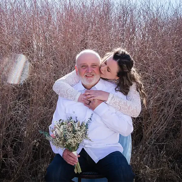 A groom is hugged by his new wife at SpiriTaos, a micro-wedding venue in Taos NM