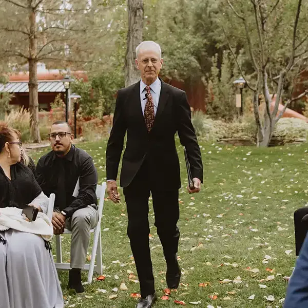 Dan Jones walks down the aisle to begin a wedding ceremony in Taos New Mexico