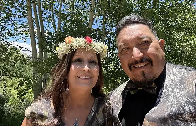 Freshly hitched couple smiles for the camera after being married by Dan Jones