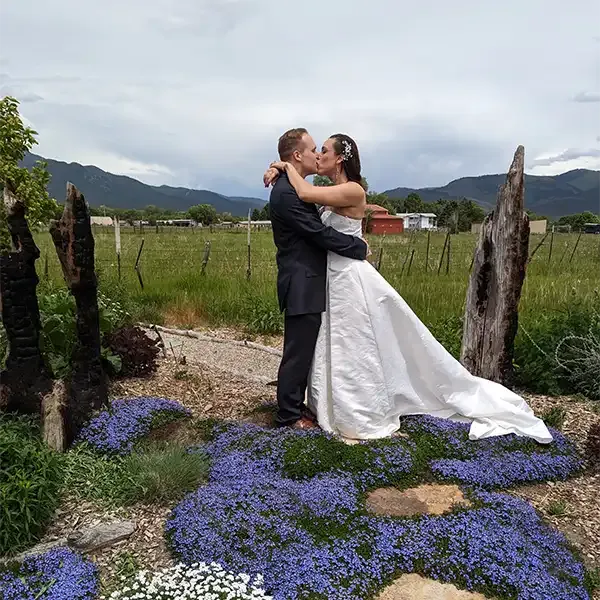 Gorgeous flowers sprawl at the feet of a newly eloped couple at SpiriTaos