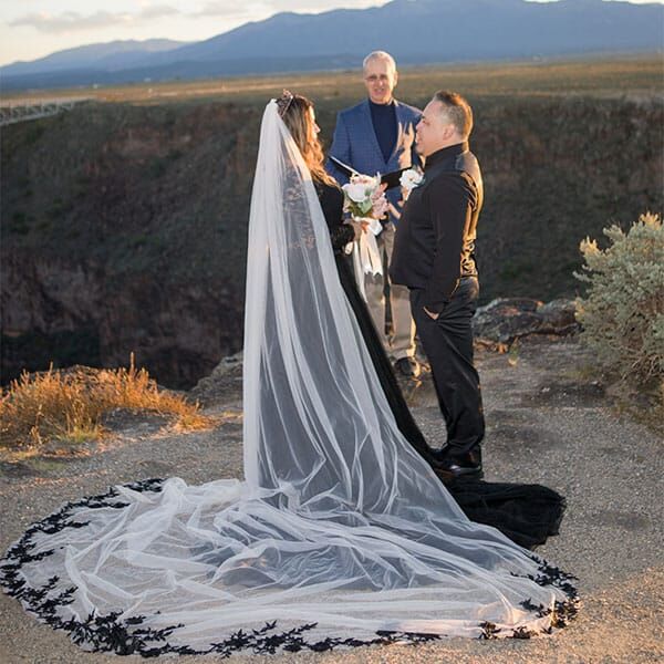 During her ceremony, the bride's wedding veil spreads out on the ground around her