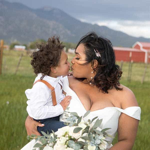 Bride kisses her son after the wedding ceremony at SpiriTaos Gardens