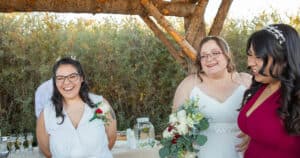 Happy brides celebrate after their ceremony by Dan Jones